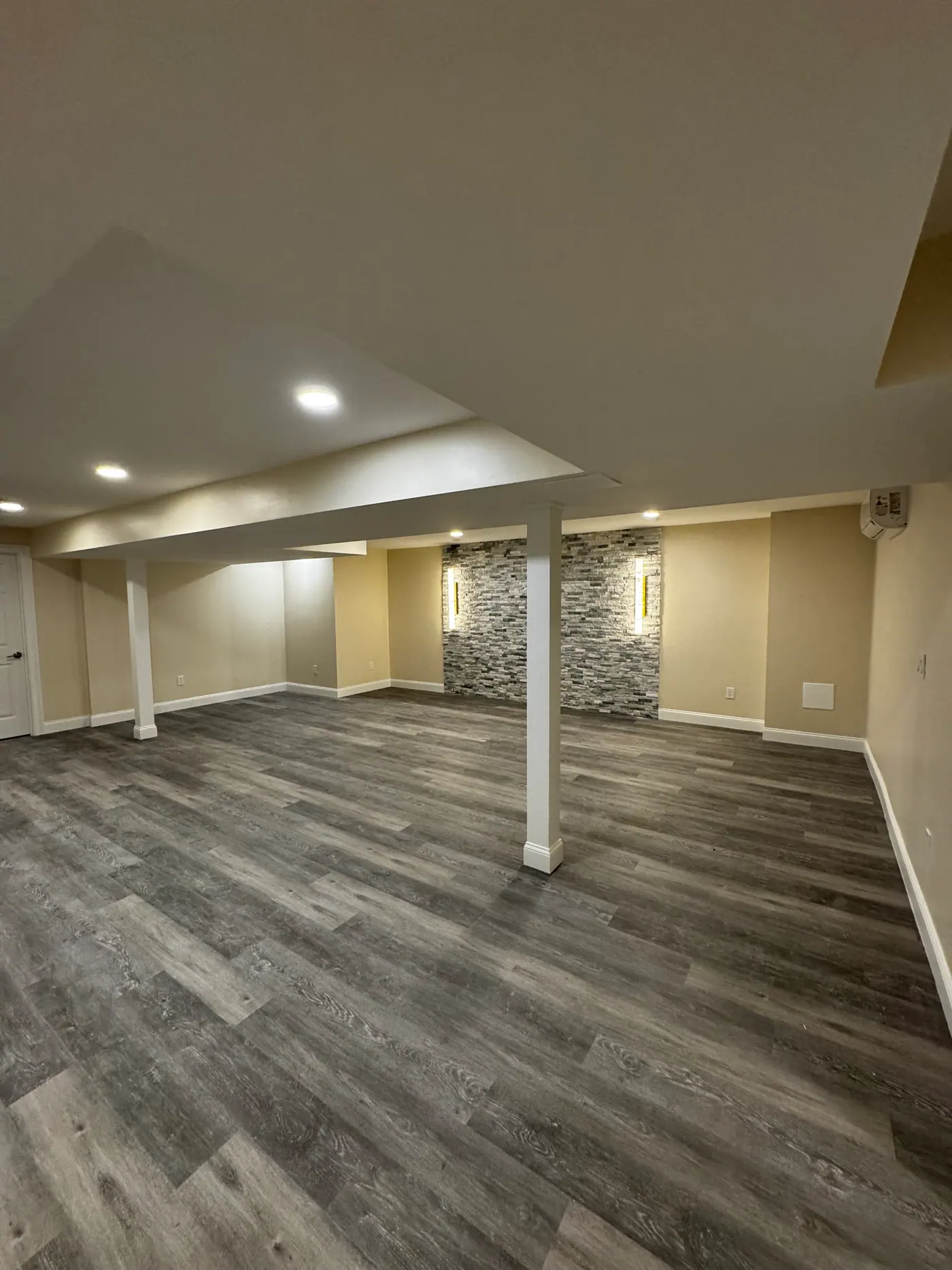 Open Basement Build-Out — Stacked stone niches and column wraps