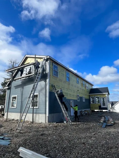 Siding Installation — Our crew working the elevation