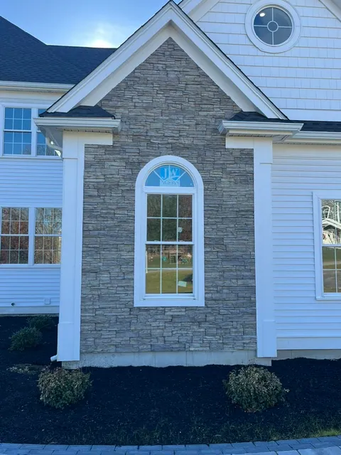 Stone veneer and arched window exterior detail