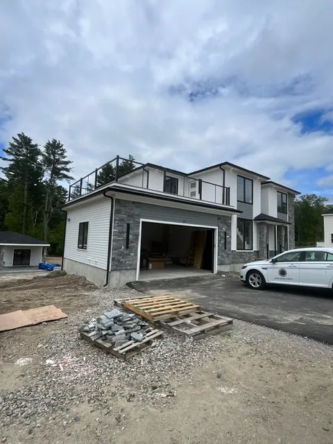 Modern Build — Stone, siding and roof deck