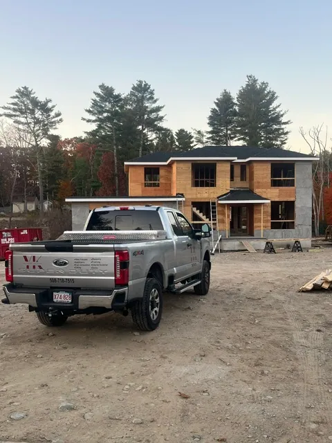 YK United Builders truck parked at a framing job site